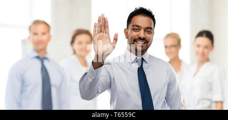 indian businessman making high five gesture Stock Photo