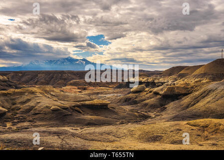 Badlands in Utah with snowy mountains Stock Photo
