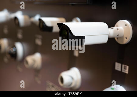 White cctv cameras for surveillance are seen arranged. Stock Photo