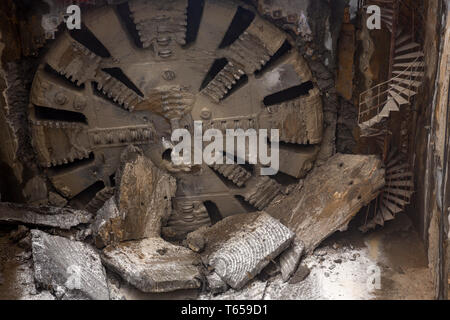 Tunnel Boring Machine front head element is seen on a subway station under construction. Stock Photo