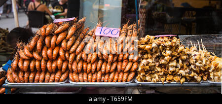 Grilled prawns and squids on the bbq for sale in Bangkok, Thailand Stock Photo