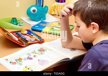 boy doing homework  with color pencil Stock Photo