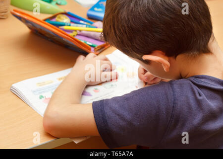 boy doing homework  with color pencil Stock Photo