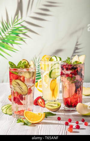 Cold summer fruit lemonade drinks, refreshment infused water. Summer drinks with ice. Stock Photo