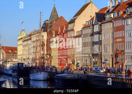 Historic 17th and 18th century buildings along the Nyhavn canal, entertainment district lined with colorful townhouses, bars and cafes, Copenhagen, De Stock Photo