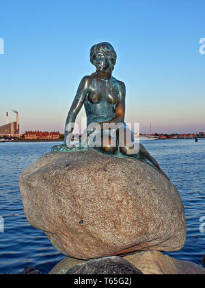 Denmark, Copenhagen, The Little Mermaid is a bronze statue by Edvard Eriksen, depicting a mermaid becoming human. The sculpture is displayed on a rock Stock Photo