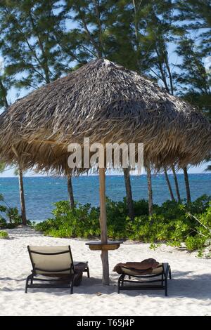 Chairs and tiki on beach in Montego Bay, Jamaica Stock Photo