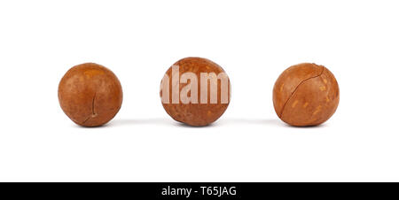 Close up three macadamia nuts isolated on white background, low angle side view Stock Photo