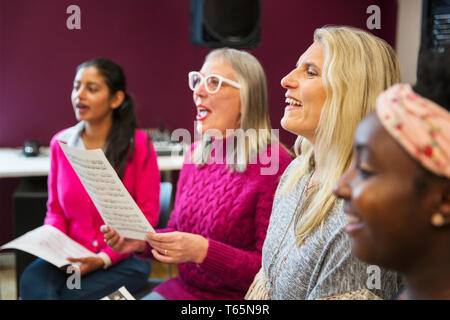 Womens choir singing in music recording studio Stock Photo