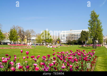 Flower beds and people having picnics in Imperial Square and Imperial Gardens Cheltenham Spa Gloucestershire England UK GB  Europe Stock Photo