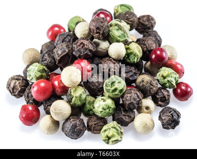 Black, white, green and red peppercorns isolated on white background. Stock Photo