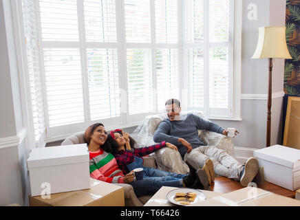 Family taking a break from packing, moving house Stock Photo