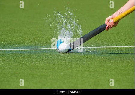 hockey player with ball in attack playing field hockey game Stock Photo