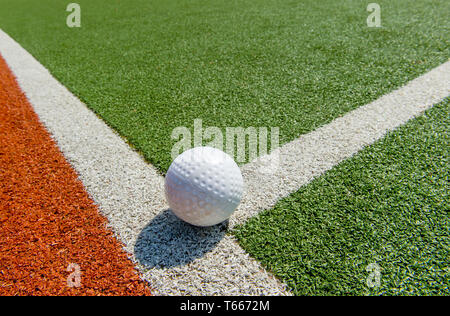 White dimple hockey ball on astro turf Stock Photo