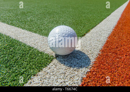 White dimple hockey ball on astro turf Stock Photo