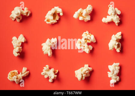 Popcorn pattern on red background. Flat lay Stock Photo
