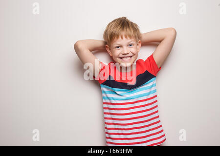 Little smiling boy in t-shirt isolated on white background. Studio portrait Stock Photo