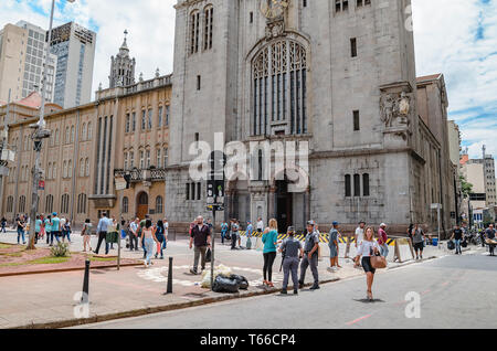 Sao Paulo SP, Brazil - February 27, 2019: People on the streets in front of Monastery of Sao Bento. Historical church on downtown. Stock Photo