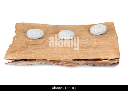 three stones on a grunge wood isolated on white ba Stock Photo