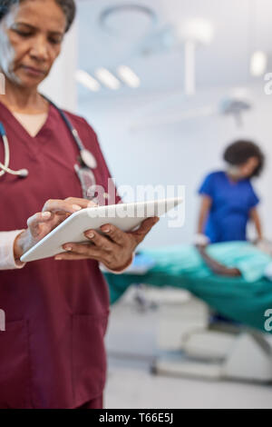 Female doctor using digital tablet in clinic Stock Photo