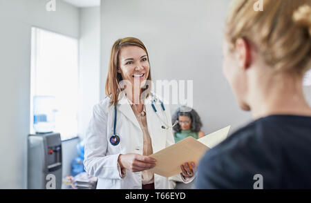 Female doctor and nurse talking in clinic Stock Photo