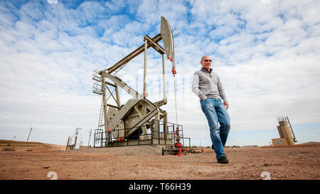 Bill Maloney, then executive Vice President in Statoil (now Equinor) next to a well pump at the newly aquired oil wells in the Bakken Shale Oil field. Statoil bought the wells and prospects from the Brigham Oil company. Maloney is now on the board of directors at Trident Energy and ATX Energy. Stock Photo