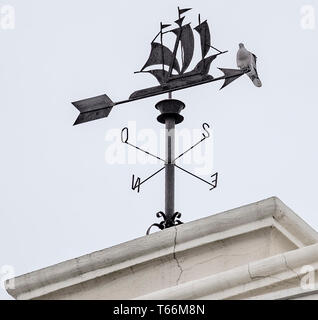 Sailing ship weathervane with a pigeon on top Stock Photo