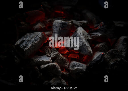 Hot, red glowing coal in a barbeque grill getting ready for BBQ cooking. Stock Photo