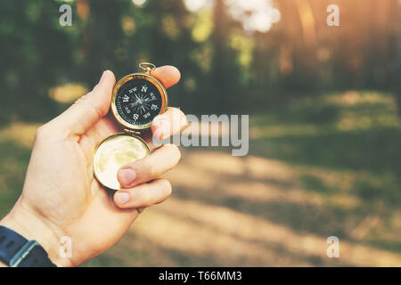 orienteering in the woods compass in the hand Stock Photo