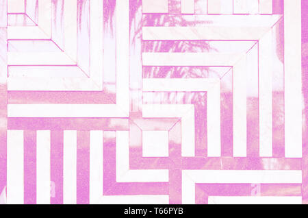 Neon toned psychedelic background. Linear, angular pattern of marble tiles on the wall. Reflection of the palm leaf. Stock Photo