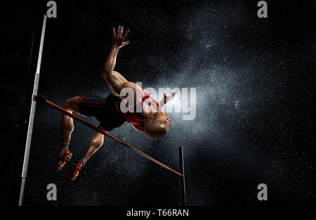 Male track and field athlete high jumping Stock Photo