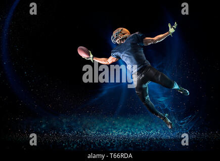 Football player reaching to catch football Stock Photo