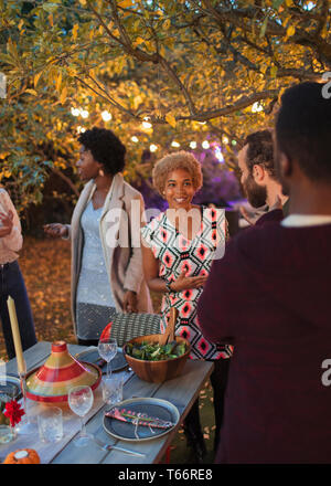 Friends talking at dinner garden party Stock Photo