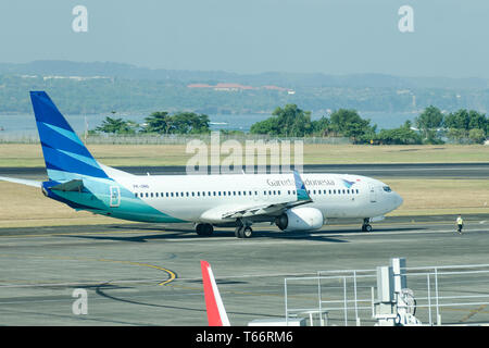 Indonesia, Bali, Denpasar, 2018-05-01: Plane by Garuda Indonesia airlines is taxiing to the runway. Stock Photo