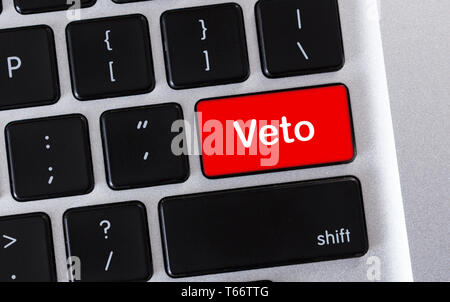 Prohibition concept. Word Veto written on red button of computer keyboard. Stock Photo