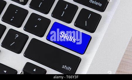 Education concept. Written word Skills on blue keyboard button, closeup Stock Photo