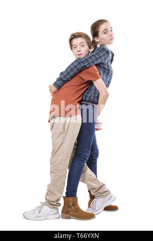 teenager siblings hugging back on back, isolated on white Stock Photo