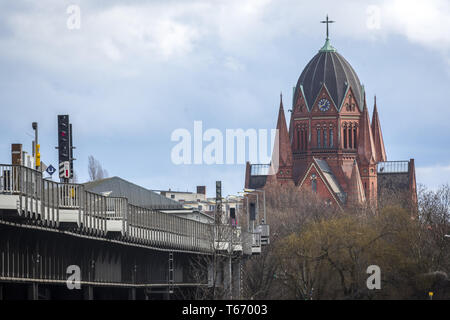 red Berlin church with railroad bridge in front Stock Photo