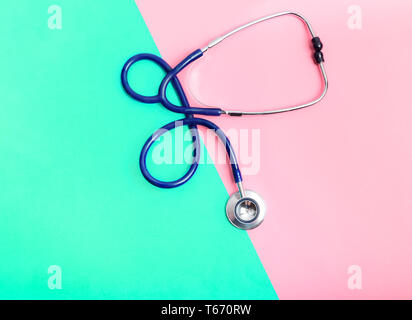 Stethoscope between green and red areas, the concept of the boundary of health and illness, healthy and unhealthy lifestyle. Risk of heart disease or  Stock Photo