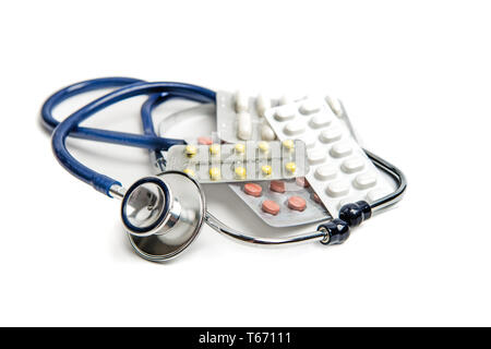 Stethoscope and pills on white medical background Stock Photo