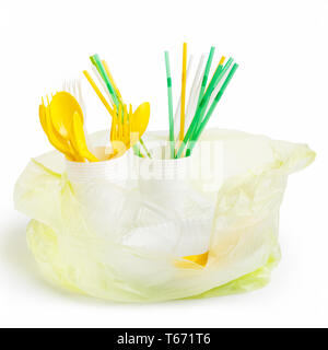 Plastic bag full of colored plastic utensils isolated on white background Stock Photo