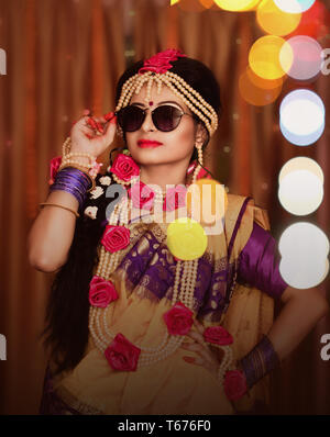Indian wedding. Morning preparations . Portrait of attractive Hindu bride wearing sunglass Stock Photo