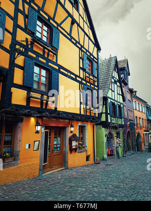 Central street of Riquewihr- one of the most beautiful villages in Alsace, France with colorful traditional half-timbered houses. Stock Photo