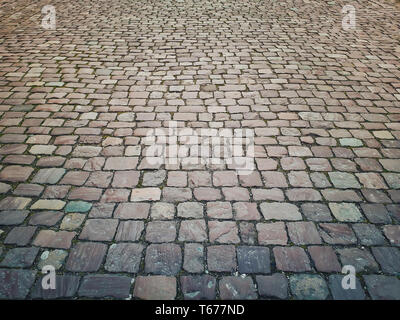 Old stone vintage pavement texture. Granite cobblestoned abstract background. Stock Photo