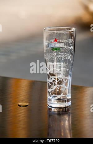 remnants of the foam in empty glass and tip the waiter Stock Photo