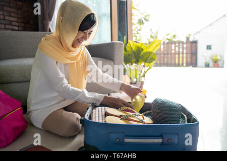 muslim asian woman preparing and packing Stock Photo
