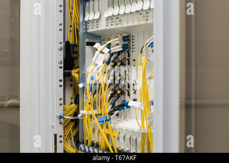 fiber optic datacenter with media converters and optical cables Stock Photo