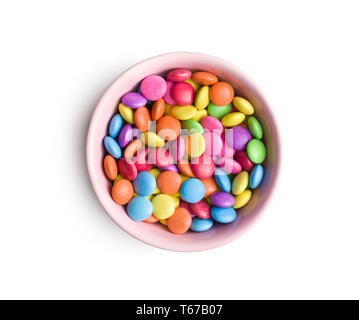 Colorful chocolate candy pills in bowl isolated on white background. Stock Photo