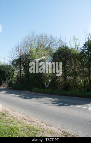 Discarded plastic waste snagged on roadside trees in Buckinghamshire. Stock Photo