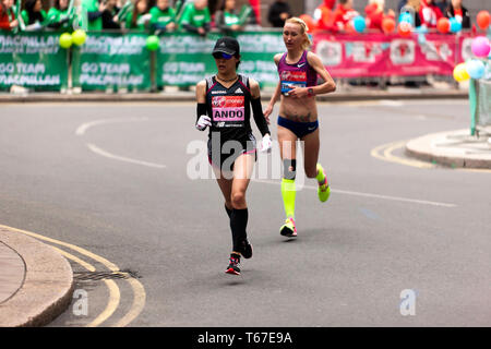 Elite Women athletes, Yuka Ando and Lilla Fiskovici, competing in the 2019 London Marathon. They  finished  in 12th and 13th places respectively. Stock Photo